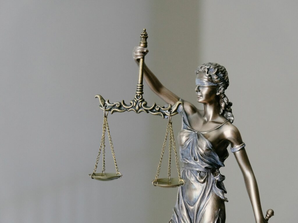 Statue blindfolded woman holding scales of justice