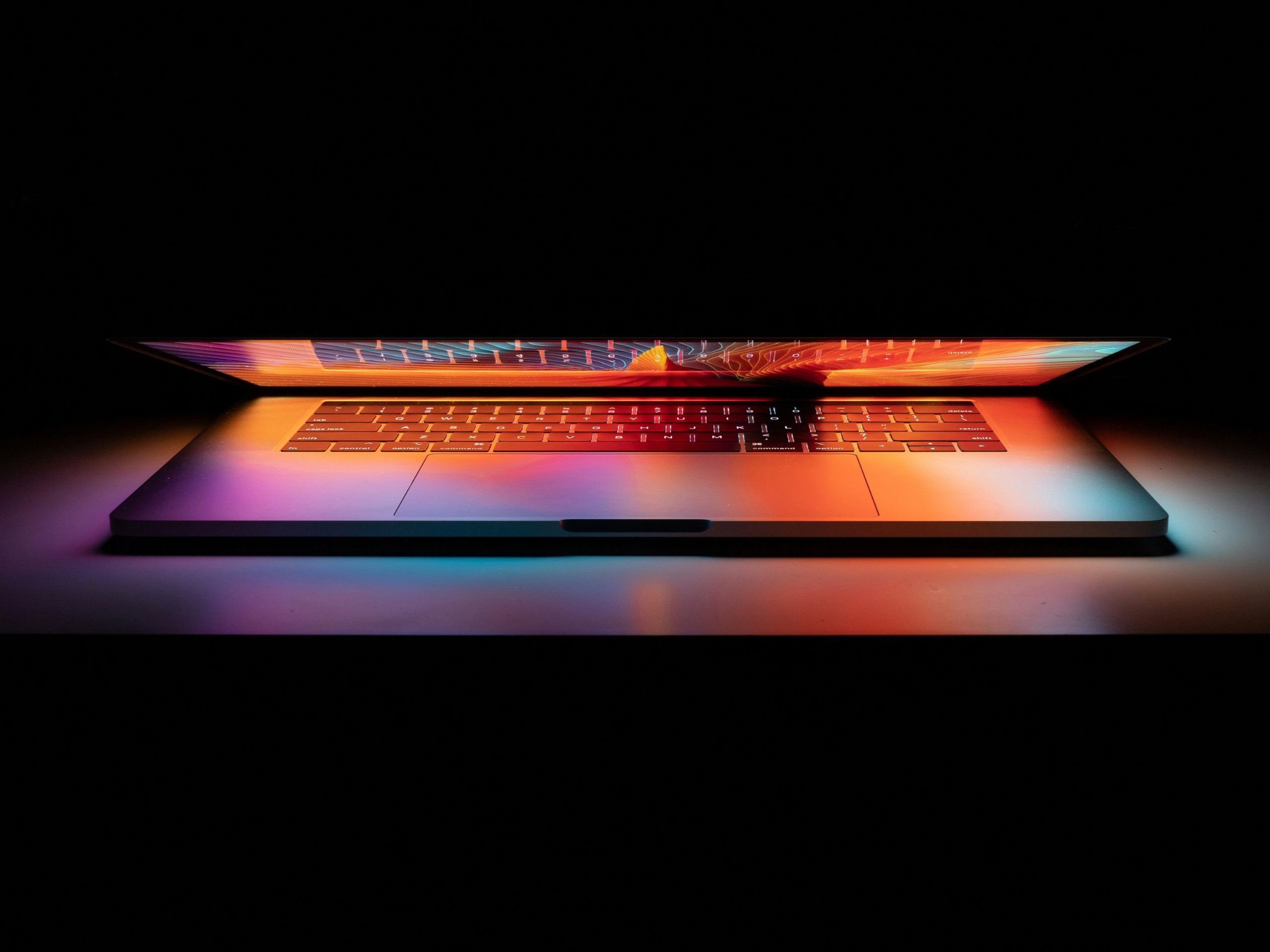 Laptop lit up with dark background