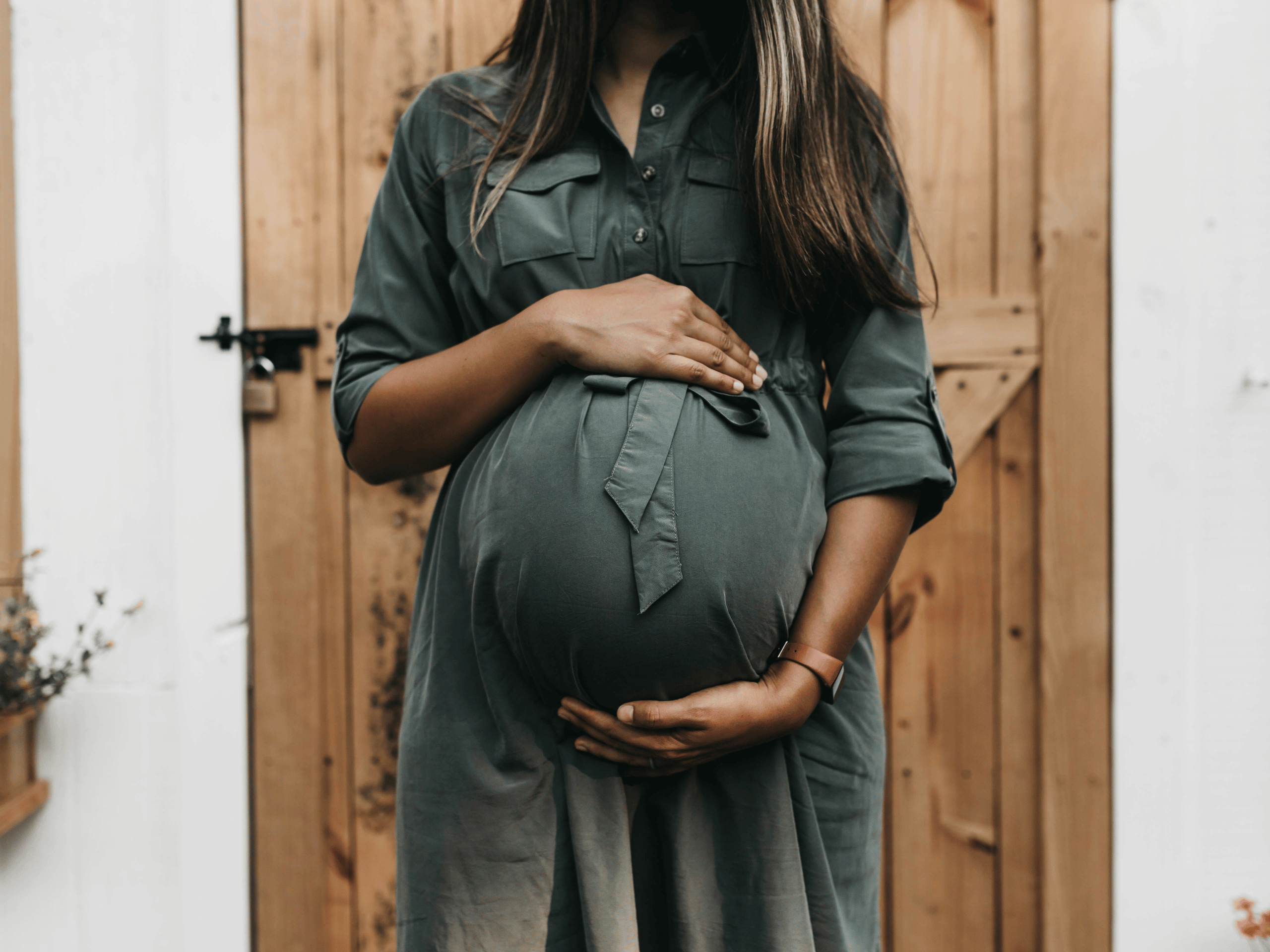 Pregnant woman holding her belly